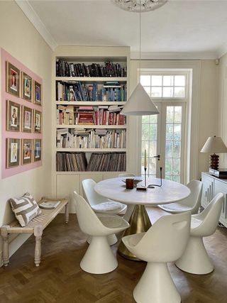 a dining room with a block of paint around a gallery wall