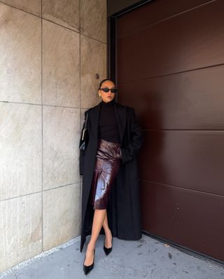 Influencer wears a leather pencil skirt.