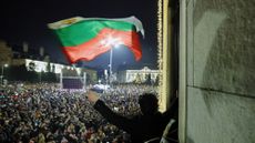 A protester waves a Bulgarian flag during demonstrations in Sofia, Bulgaria.