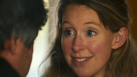 A very close up shot of Elizabeth Holmes with Nathan Field's head to the side in You Can See Everything