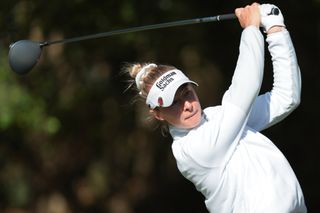 Nelly Korda strikes a tee shot with a driver