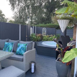 Raised hot tub in decking area of garden