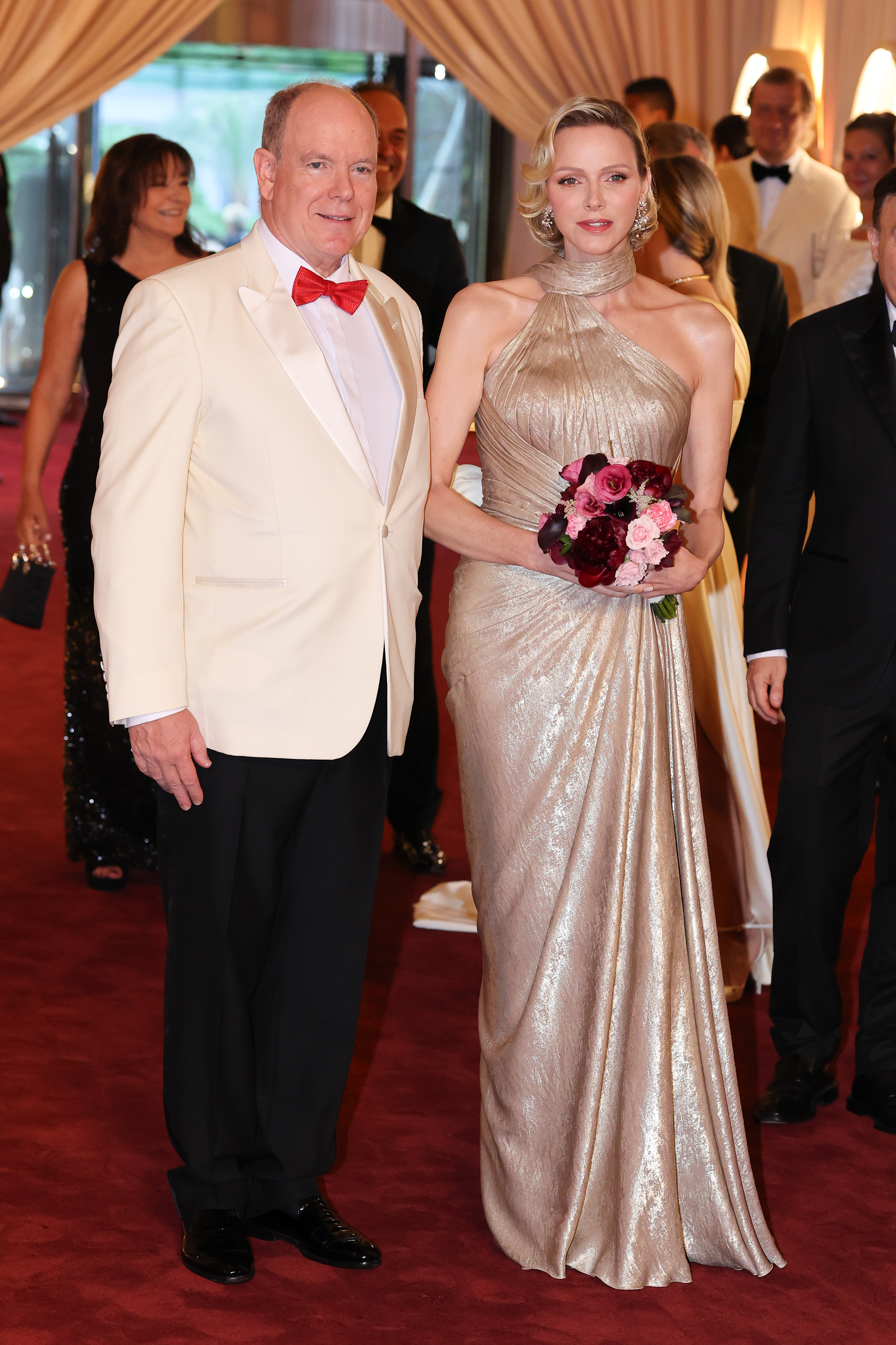 Princess Charlene wears a custom shimmering gold gown from Elie Saab, channeling her late mother-in-law Grace Kelly