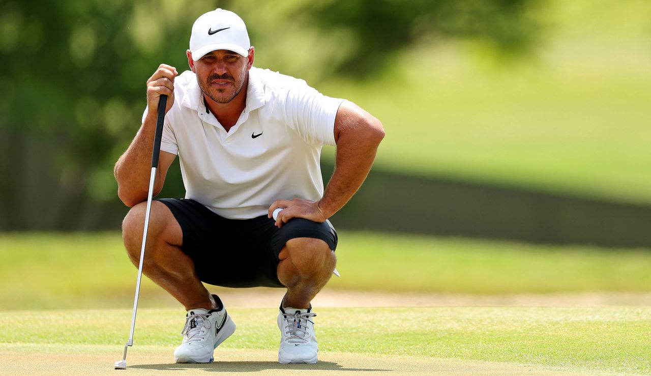 Koepka lines up a putt 