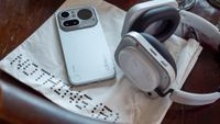 A Nothing Phone 4a Pro and a Nothing Headphone A on a Nothing-branded bag