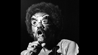 A picture of Fuzzy Haskins on stage in 1977