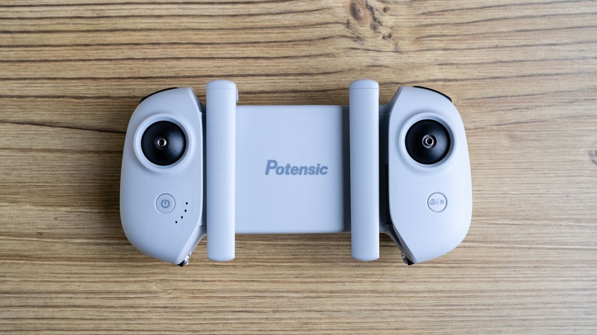 Potensic Atom SE controller on a wooden floor