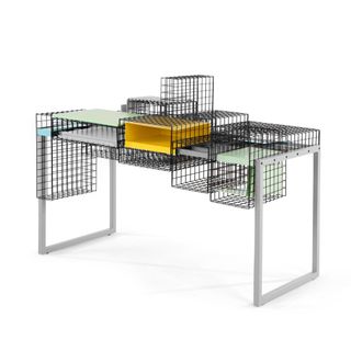 Grid Desk with silver frame and an assortment of black wire baskets and green and orange shelves