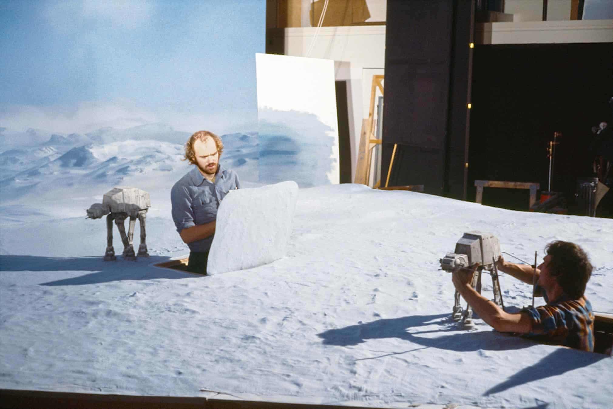 Two men on a snowy sci-fi set animating miniature walking machines
