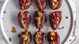 Dates filled with peanut butter and topped with seeds and nuts