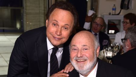 Billy Crystal and Rob Reiner smiling at Avery Fisher Hall in 2014.