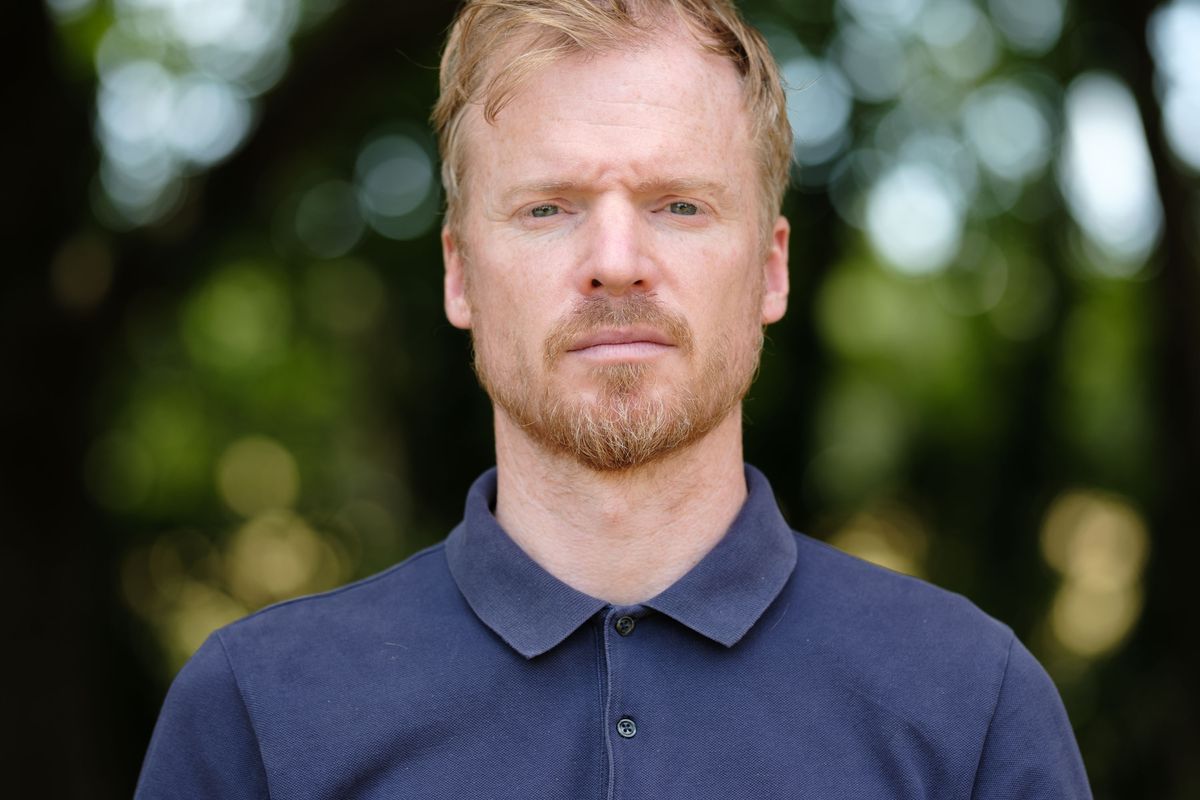 Viltrox AF 90mm F2.2 EVO and Fujifilm XF 90mm f/2 R LM WR lens comparisons: upper body portrait of a man with backlit trees