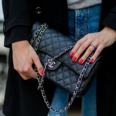 Maxilie Mlinarskij wearing a black Chanel bag and red nail polish on August 15, 2016 in Berlin, Germany