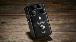 A Fender The Bends compressor pedal on a wooden floor