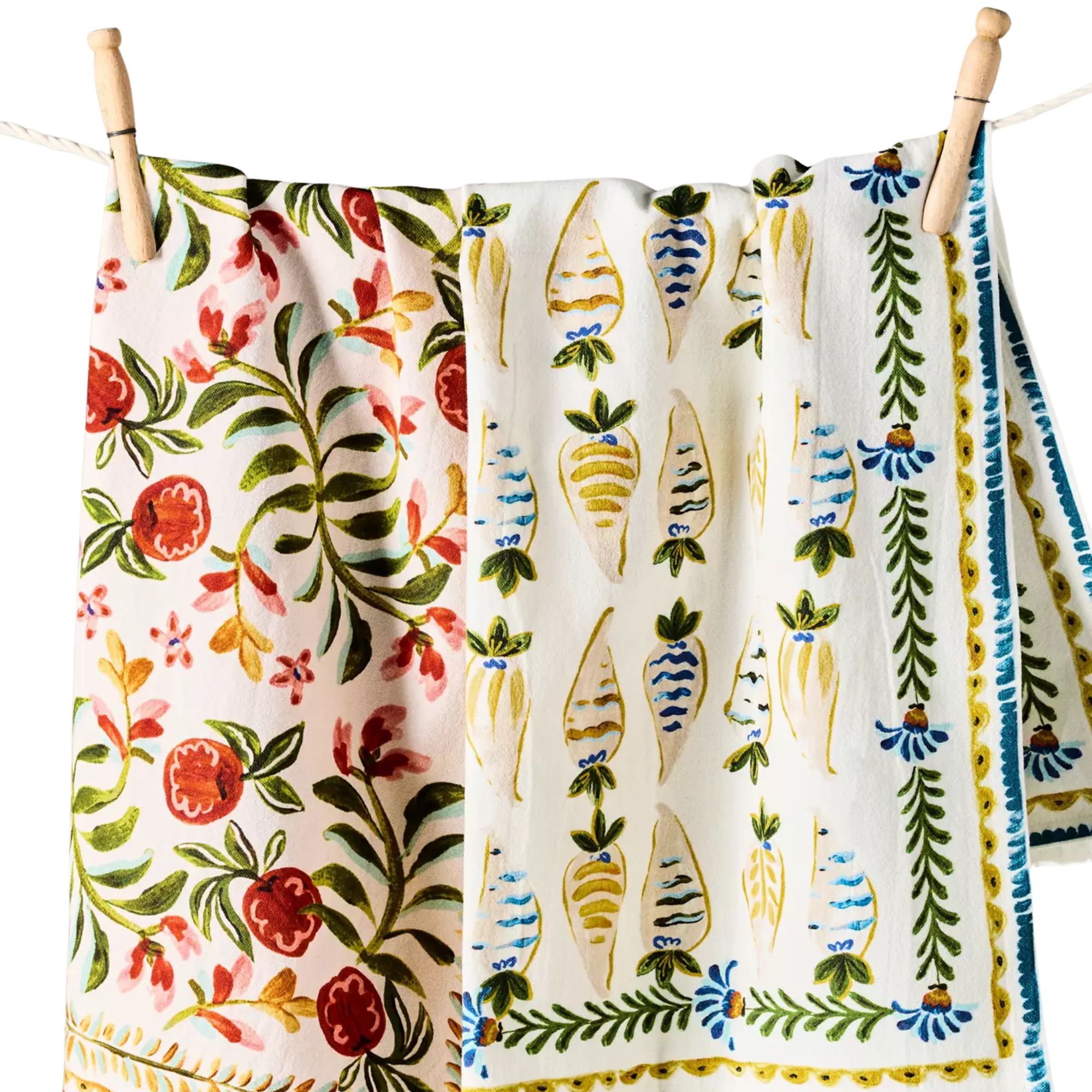 Molly Yeh patterned Dish Towels hanging on a white string with wooden pegs