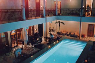 A jazz trio plays poolside, bikes in the background