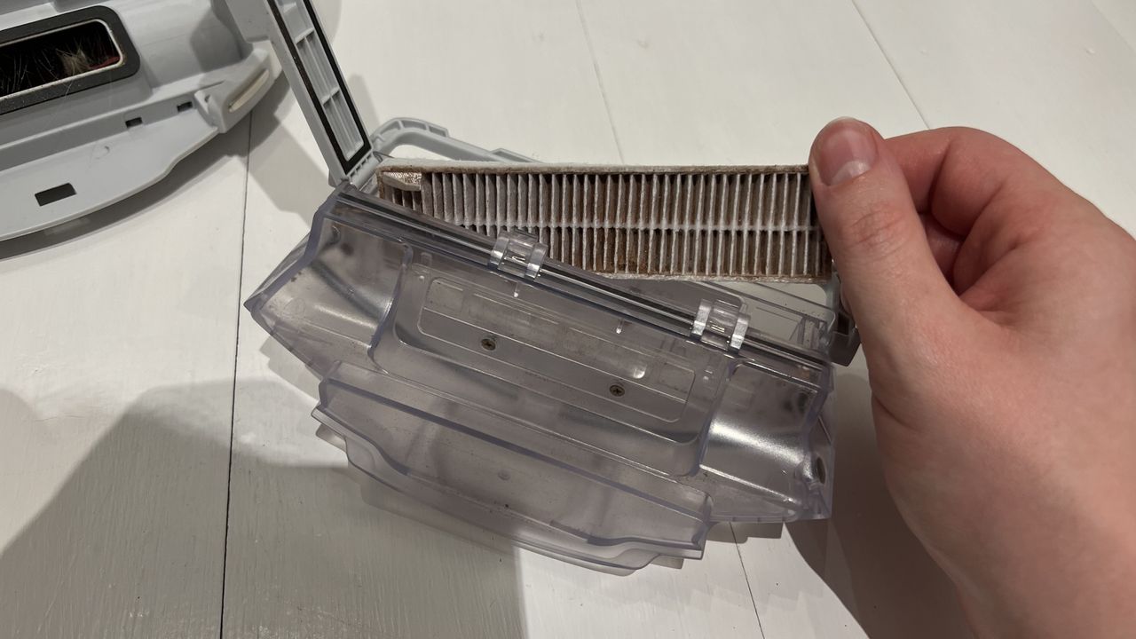 Taking out the filter that's hidden within the bin.