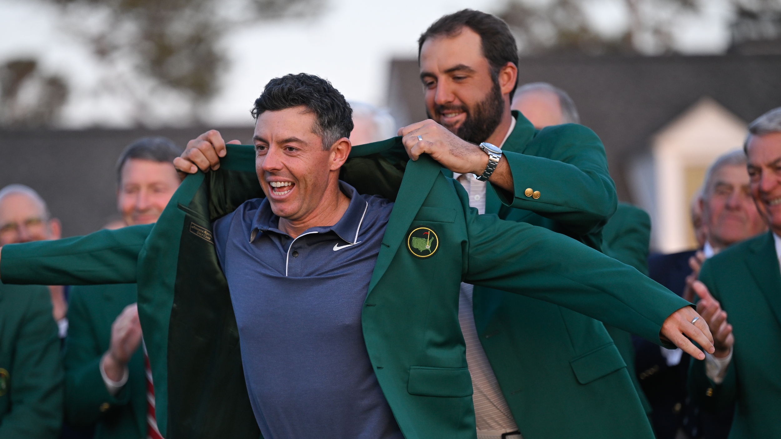 Rory McIlroy is given the Green Jacket by Scottie Scheffler