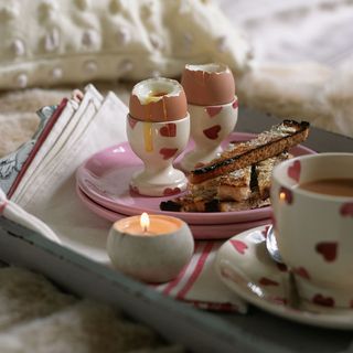 breakfast with boiled egg and tea and bread and tea and candle