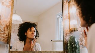 woman applying makeup