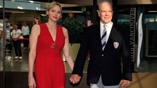 Prince Albert II of Monaco and Princess Charlene of Monaco pose after visiting the exhibition "La flamme Olympique au fil des temps" in Monaco, on July 18, 2024