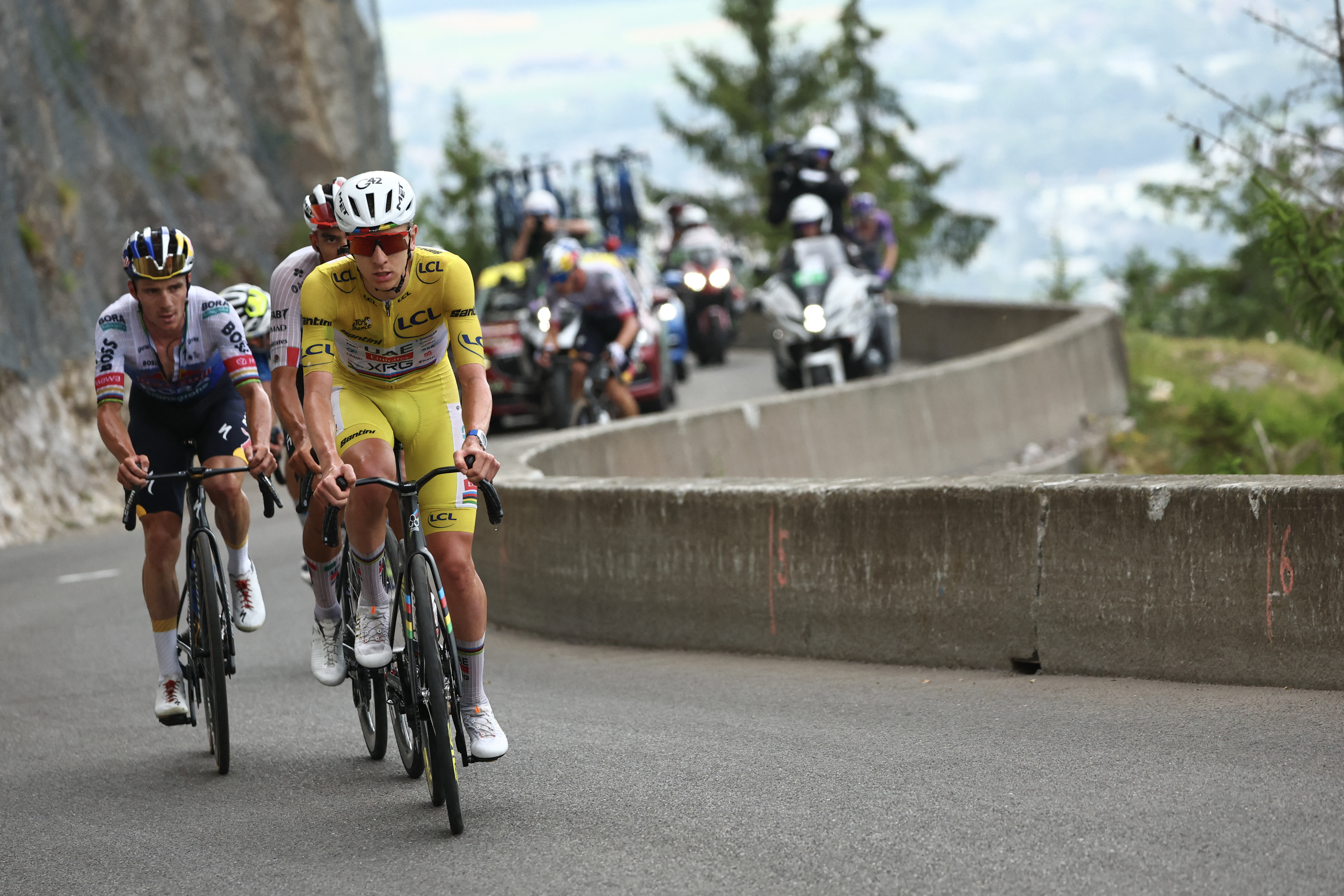 Tadej Pogacar wearing yellow jersey with Remco Evenepoel and Issac Del Toro on the final ascent of Plateau de Solaison in the Jura mountains. Stage 15 of the 2026 Tour de France