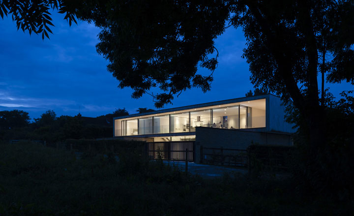 The house peeks out from below the tree line