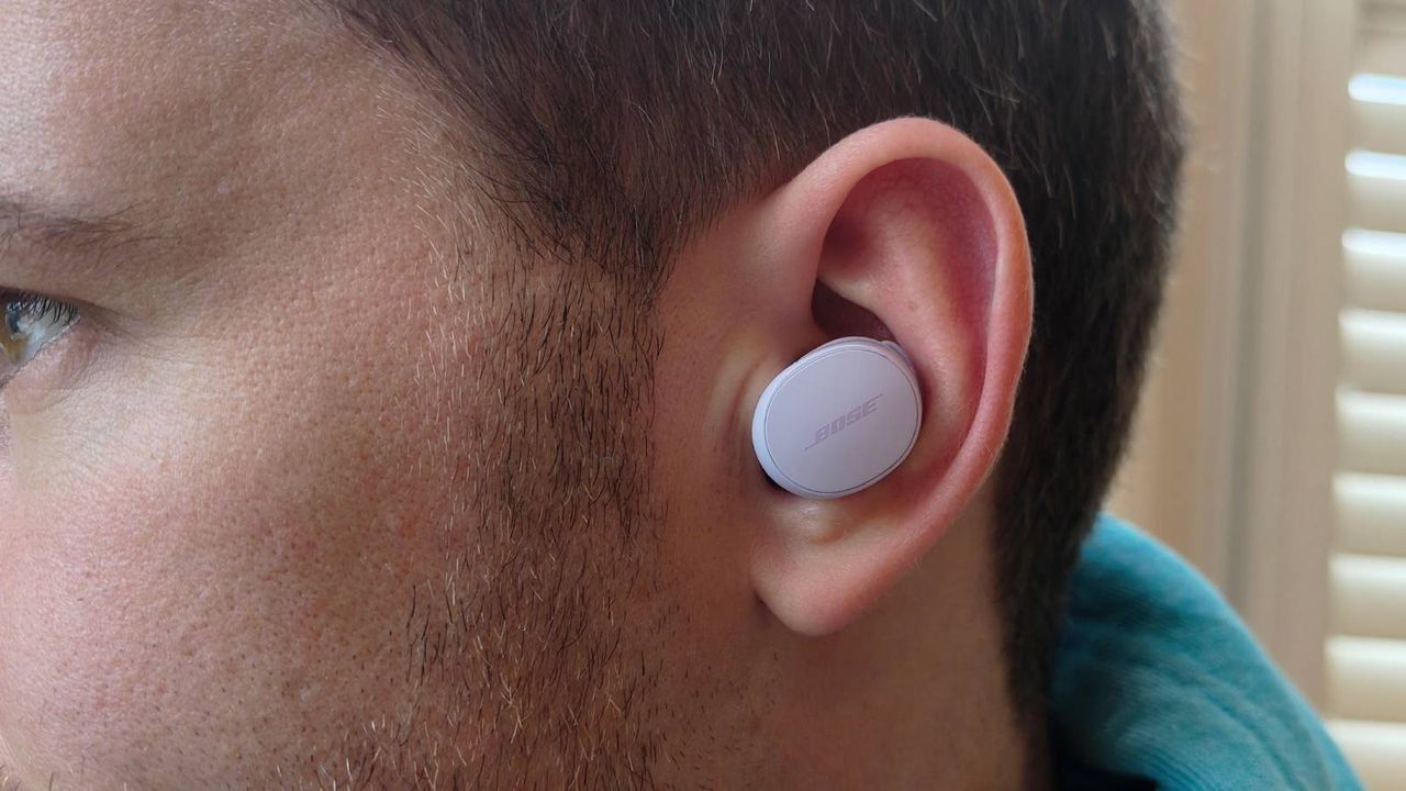 The Bose QuietComfort Earbuds 2024 on a wooden table.