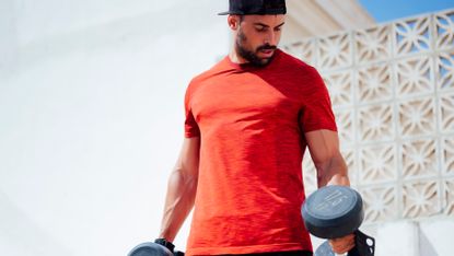 Man working out his triceps with some dumbbells