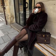 Woman in a brown faux fur coat and brown boots