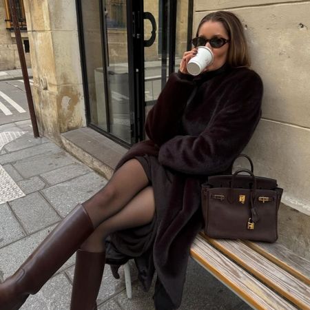 Woman in a brown faux fur coat and brown boots