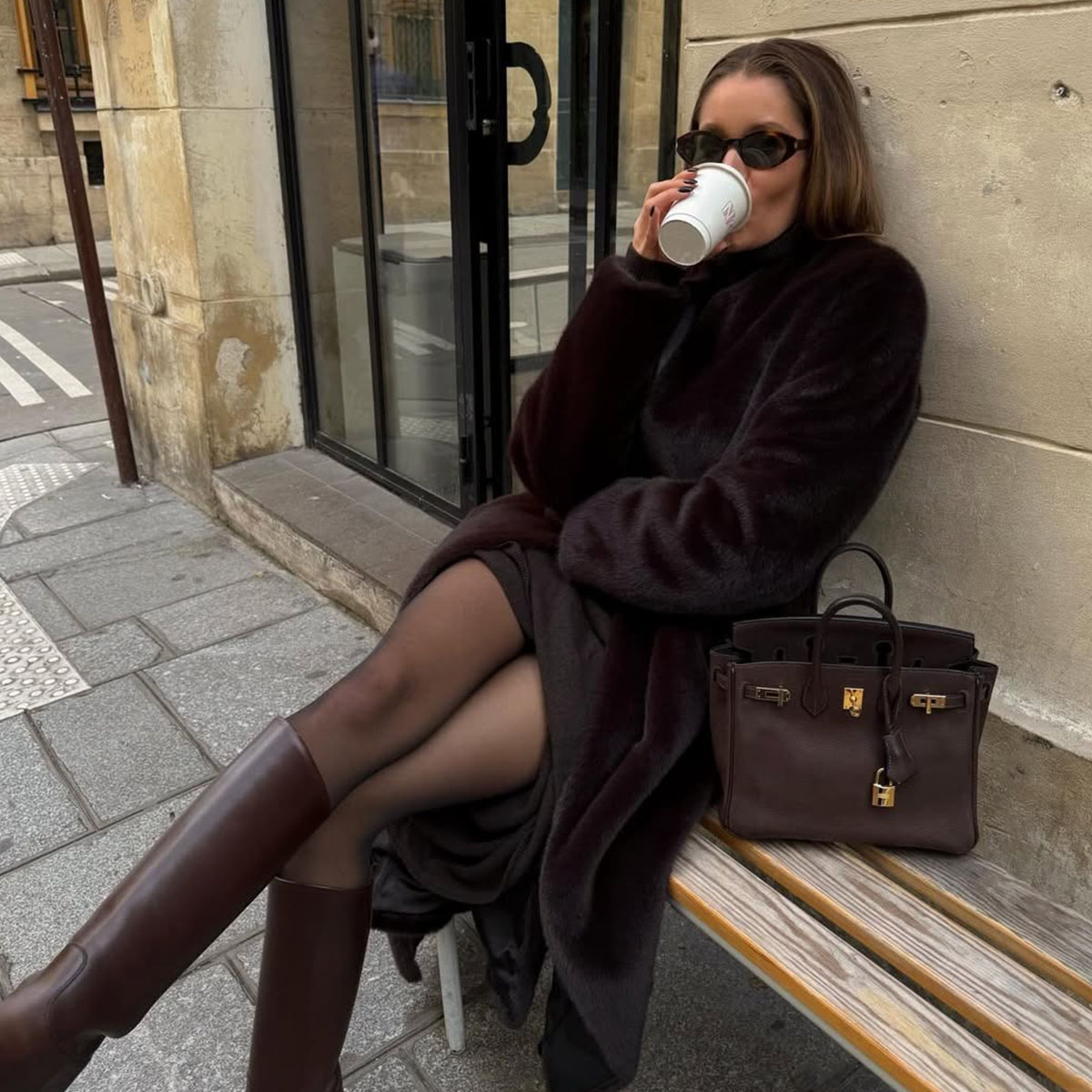 Woman in a brown faux fur coat and brown boots
