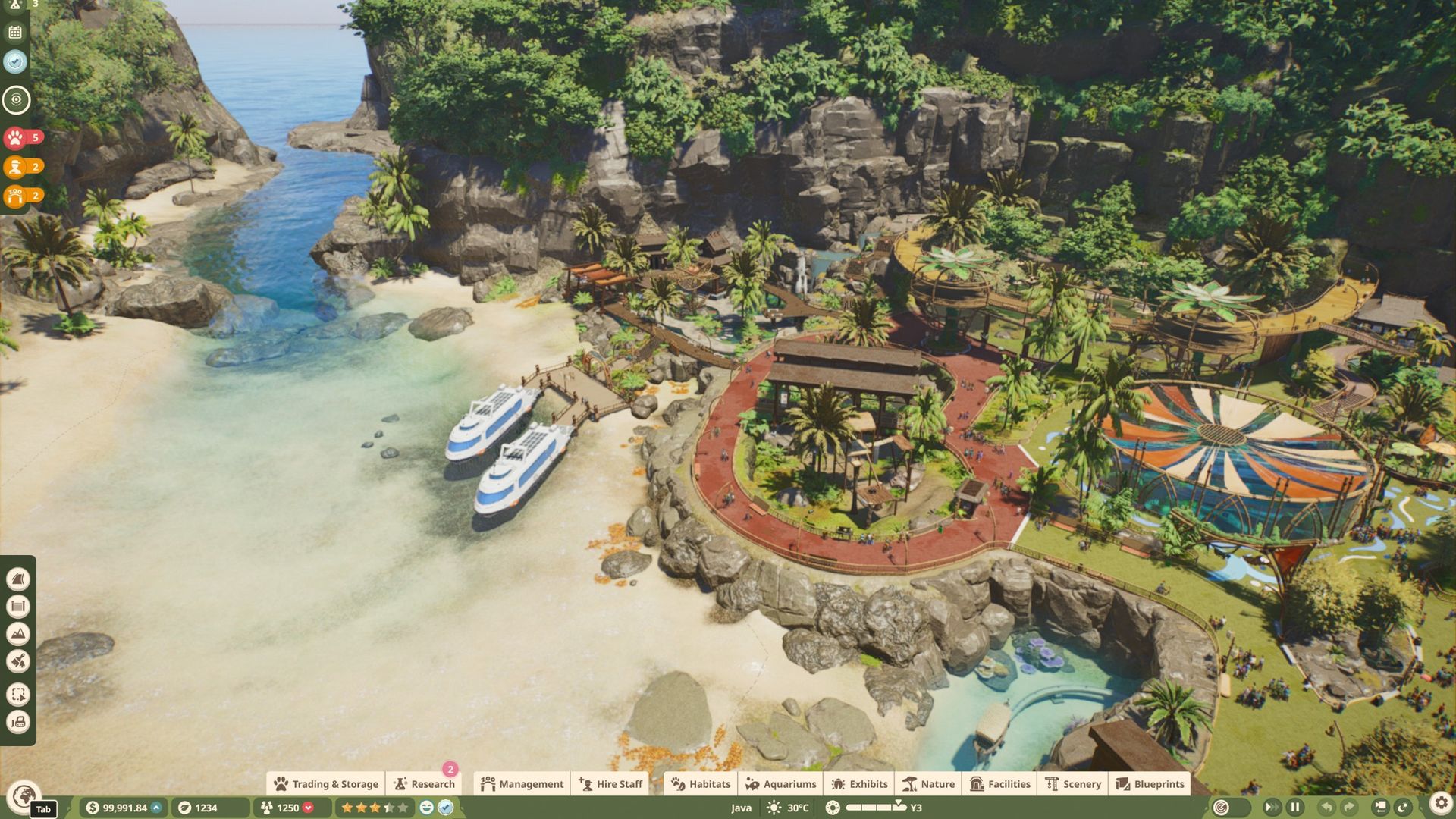 A tropical zoo in Planet Zoo 2 showing a tropical cove, habitats and lush rainforest foliage.