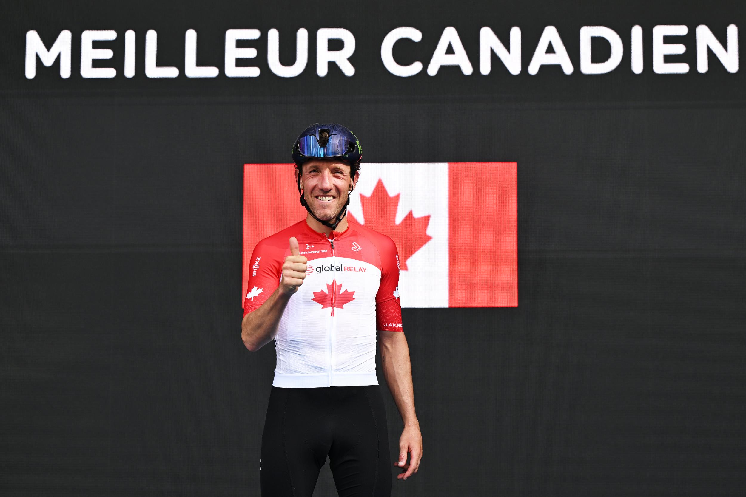 Mike Woods gives a thumbs up on the podium as the best Canadian rider at the GP de Montreal