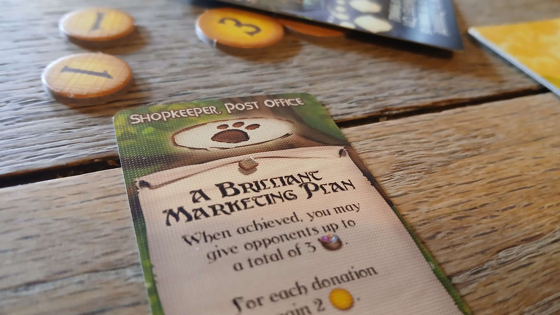 Everdell card and token components laid out on a wooden surface