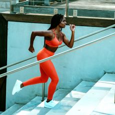 A woman doing a Stairmaster workout in the gym