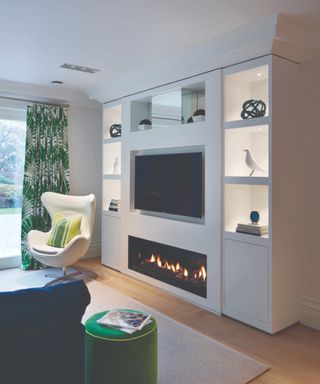 A media wall with a fireplace insert in a modern living room