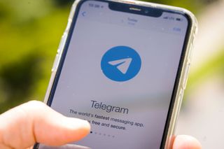 The Telegram logo on an iPhone.