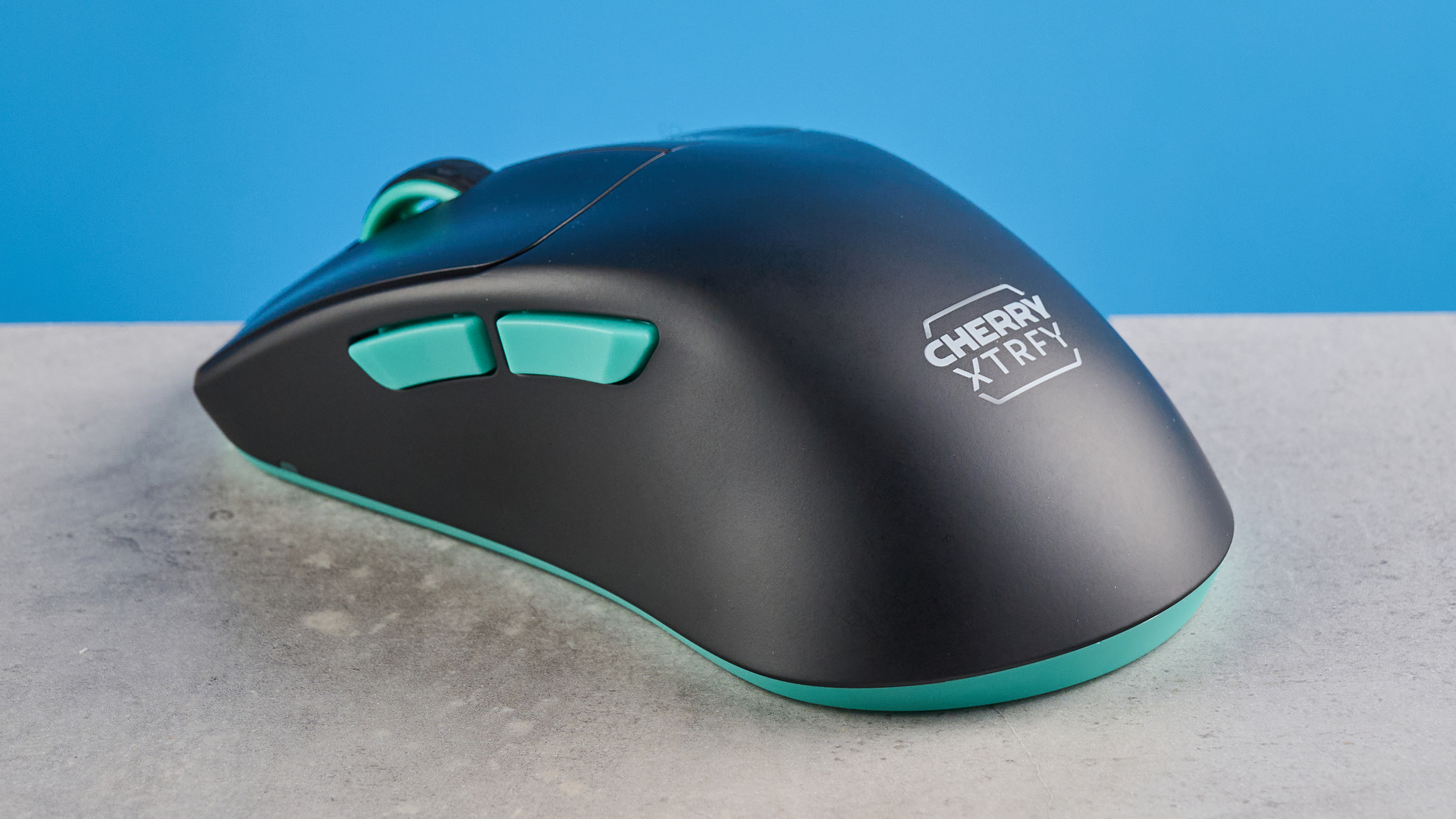A black and teal Cherry XTRFY M64 Wireless gaming mouse