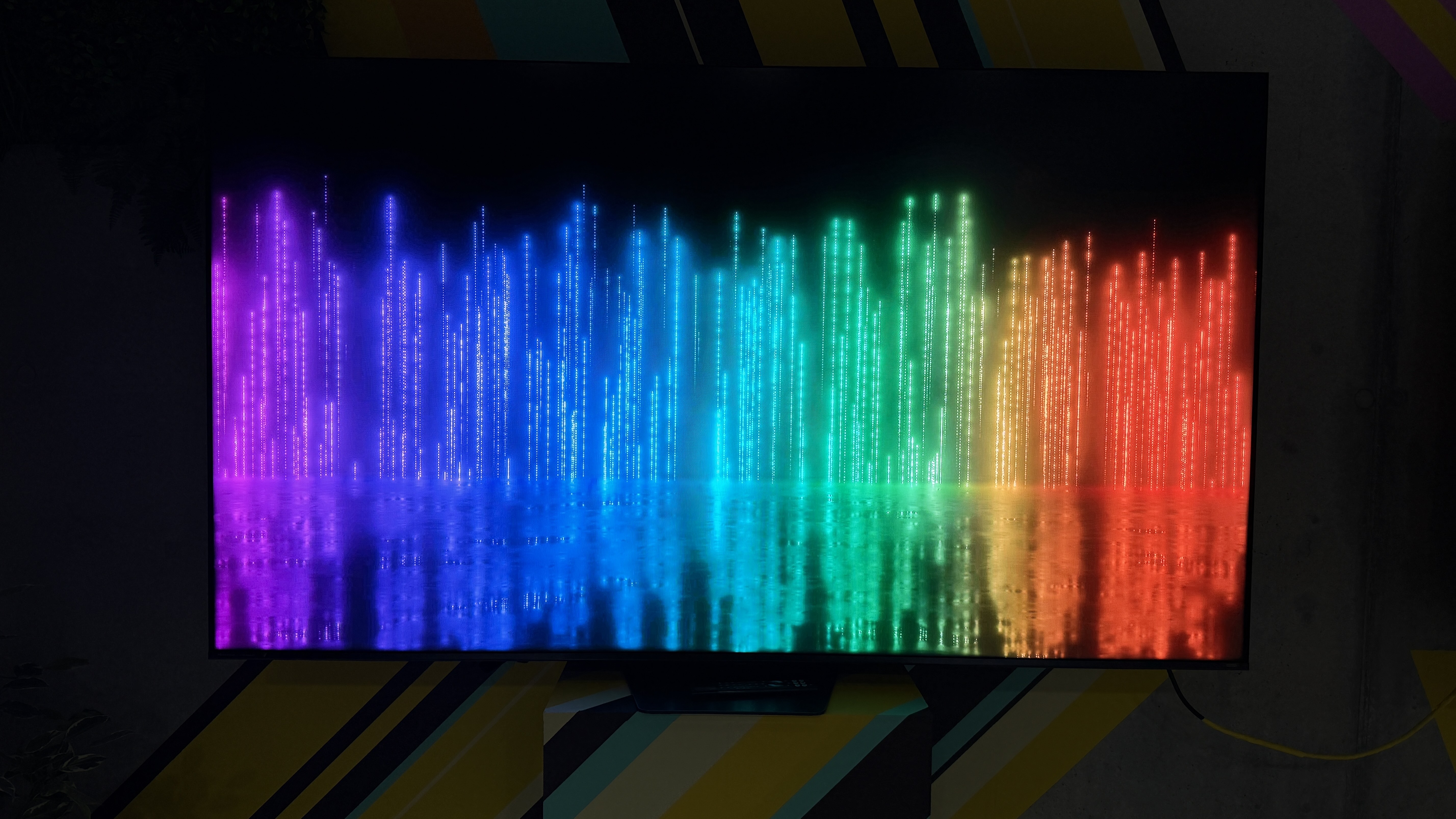 The Hisense UR9S RGB TV with lines of colors across the rainbow spectrum along the bottom two thirds of the screen. The top is dark, showing impressive contrast skills