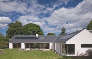 white bungalow with solar pv panels on roof