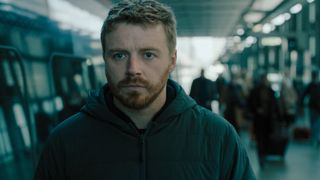 River Cartwright (Jack Lowden) on a train platform in "Slow Horses" season 4