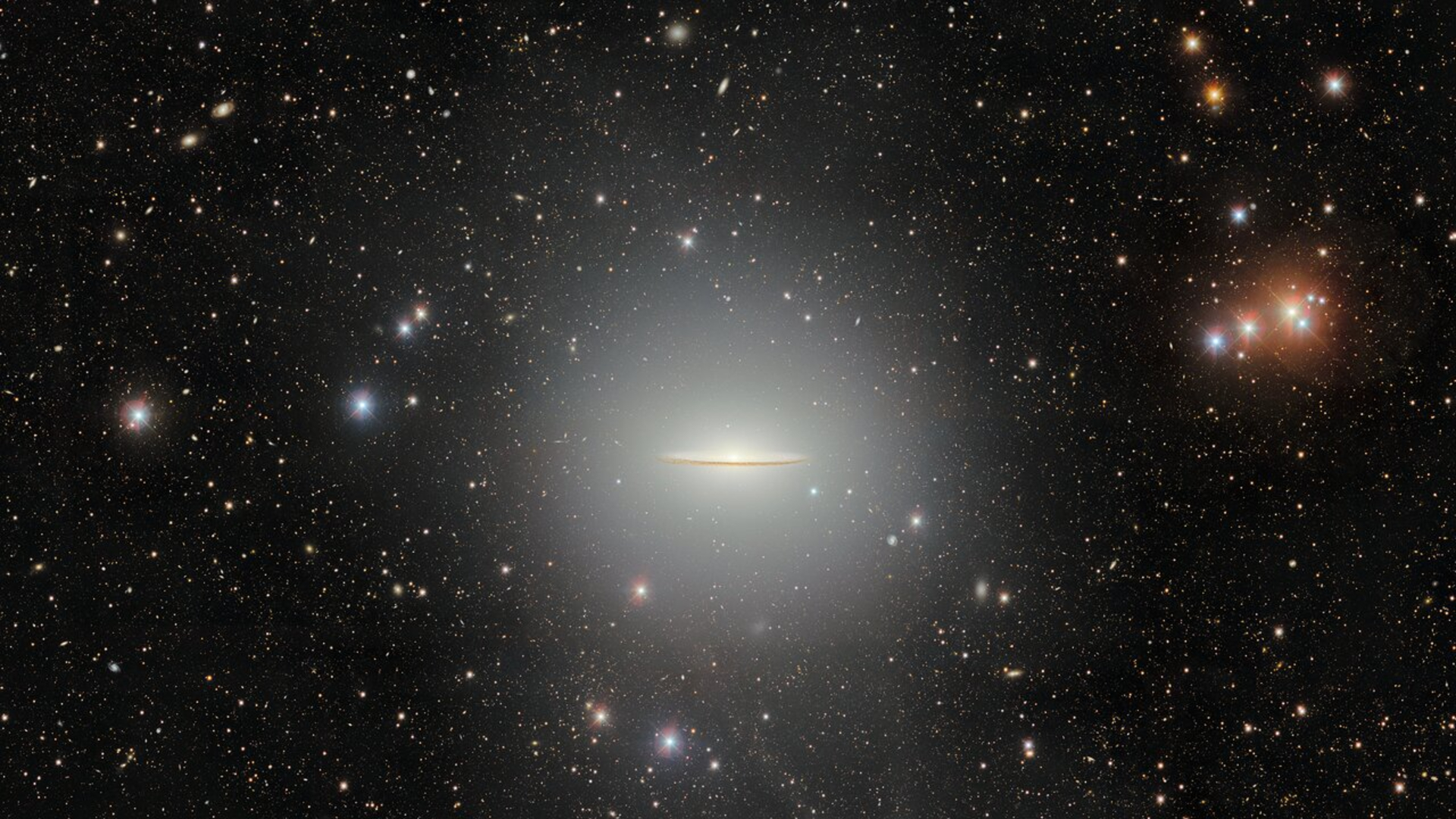A flat disk of glowing light is seen against a starry background in space. 