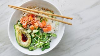 Bowl of rice, salmon and healthy fats, one of the nutritional meals to eat when you're going through menopause