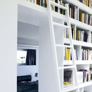 bedroom with white wall and bookshelf