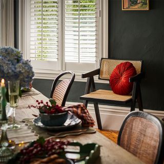 green dining room with dining table and chairs