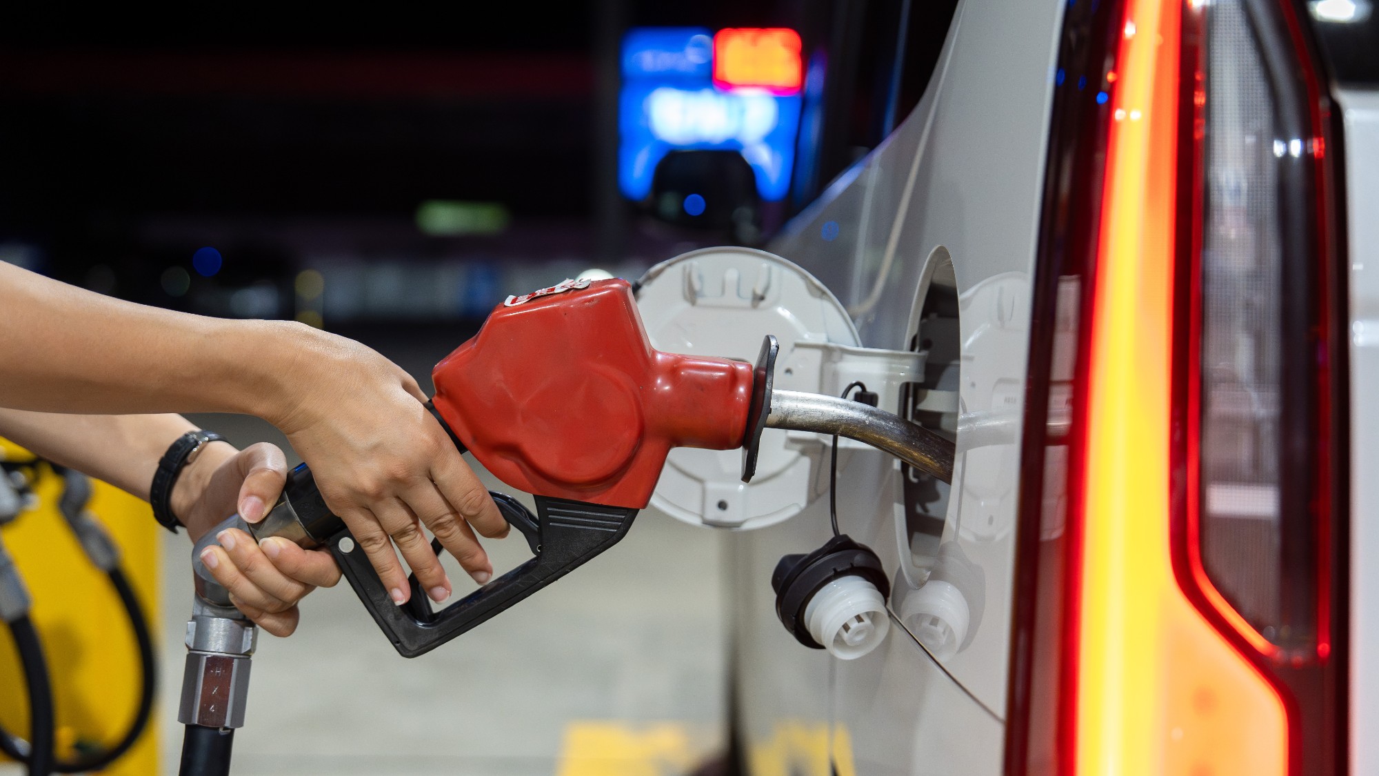 A person refueling their car at a gas station