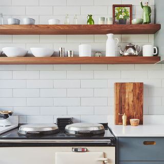 white metro tiled kitchen wall with wooden shelves