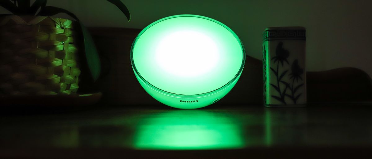 Philips Hue Go 2 displayed on table with green light