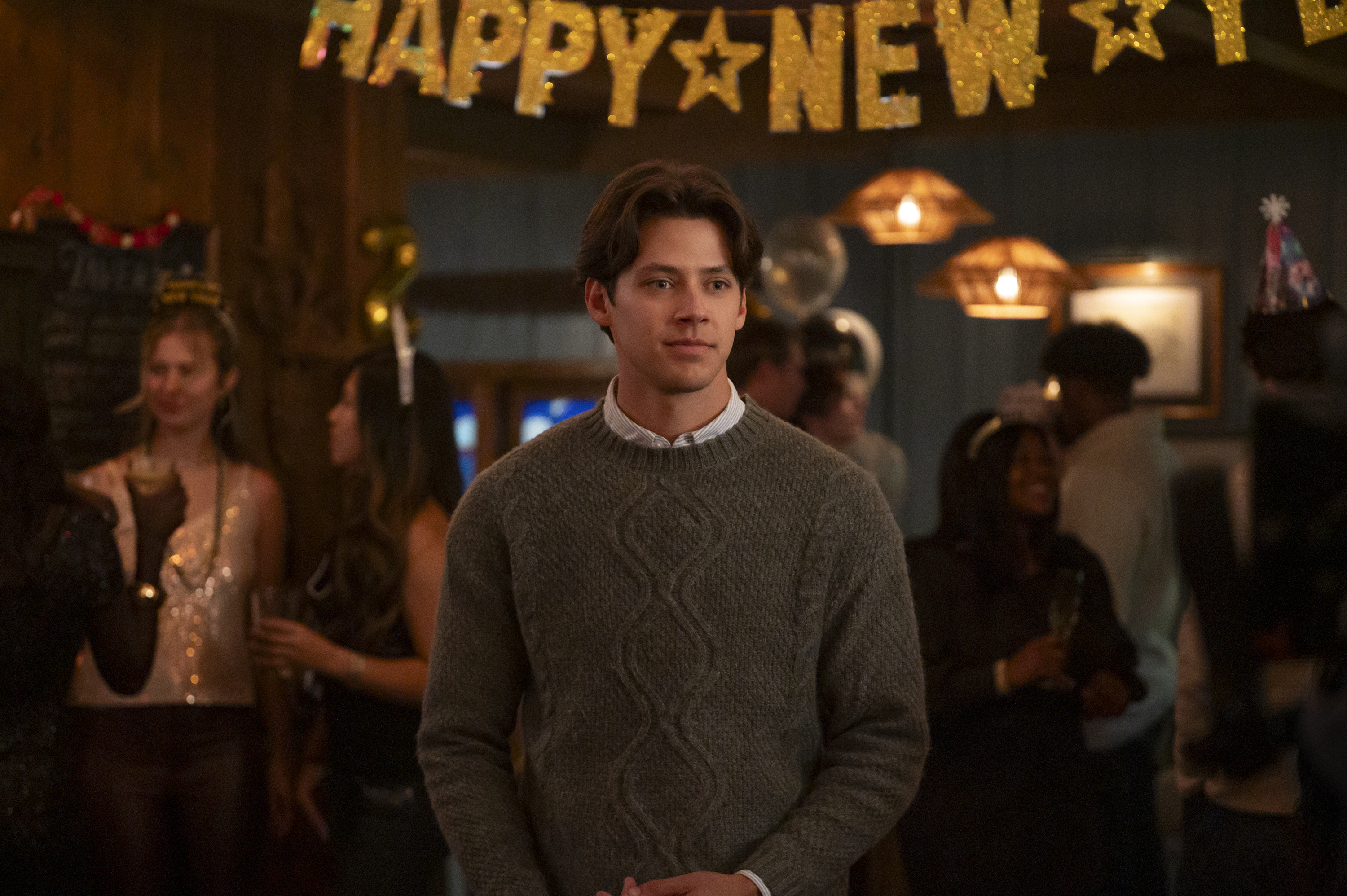 Matt Cornett as Sam Florek standing in front of a &amp;quot;Happy New Year&amp;quot; banner in 'Every Year After.'